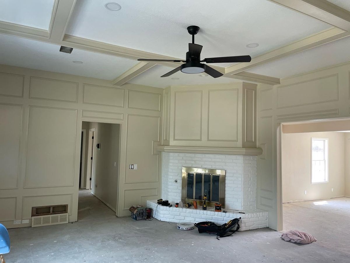 Living room with new wall paneling, coffered ceiling and white brick fireplace